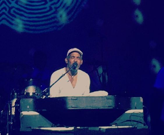 Frankie Beverly performing in a concert.