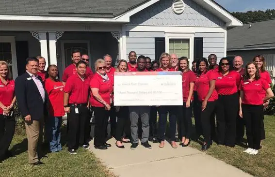 Warrick Dunn, with his charity team, thanking the Bank of America for the support