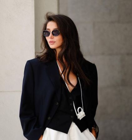 Jan KoumÃ¢â‚¬â„¢s girlfriend, Evelina Mambetova, posing in a black blazer paired with white loose-fitting pants