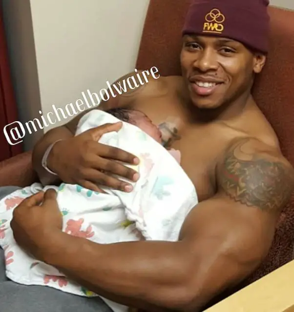 Michael Bolwaire holding his son 