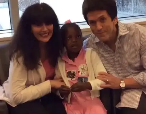 Mitch Albom and Jenine Sabino posing with her daughter, Chika