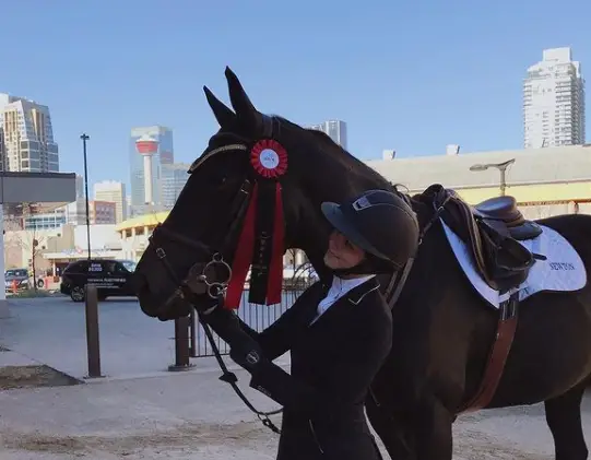 Alisha and her horse, Diva, in an event.